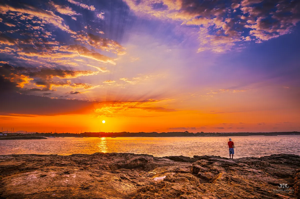 Sunrise and man fishing in Colonia de Sant Jordi